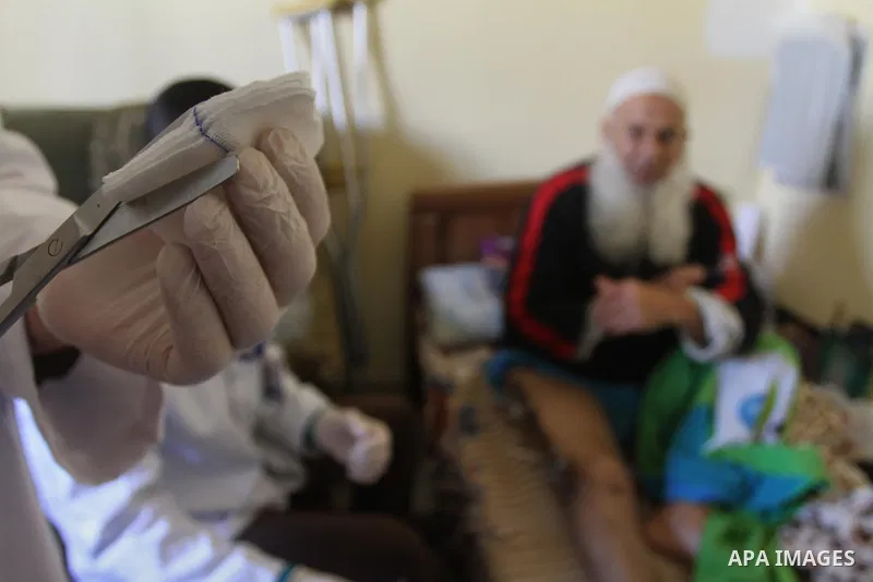 Palestinian doctors treats an elderly man at his home in Gaza City, on Feb. 22, 2014. "Ainucar Consulting and medical services" group include the Palestinian graduates doctors, nurses and medical Technology, to overcome...
