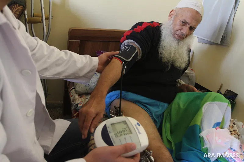 Palestinian doctors treats an elderly man at his home in Gaza City, on Feb. 22, 2014. "Ainucar Consulting and medical services" group include the Palestinian graduates doctors, nurses and medical Technology, to overcome...