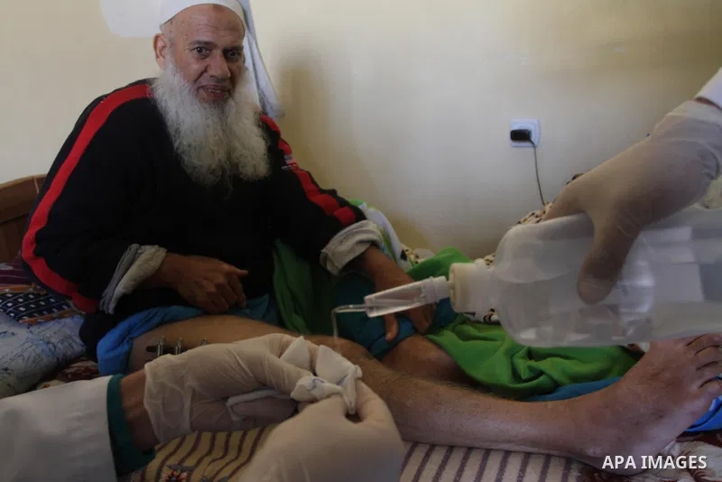 Palestinian doctors treats an elderly man at his home in Gaza City, on Feb. 22, 2014. "Ainucar Consulting and medical services" group include the Palestinian graduates doctors, nurses and medical Technology, to overcome...