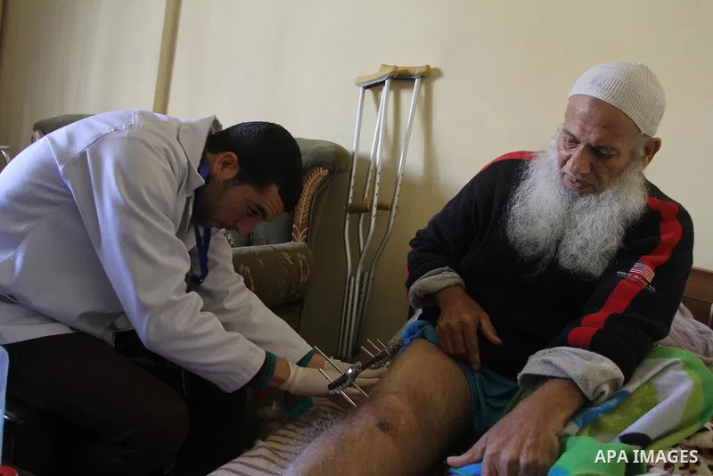 Palestinian doctors treats an elderly man at his home in Gaza City, on Feb. 22, 2014. "Ainucar Consulting and medical services" group include the Palestinian graduates doctors, nurses and medical Technology, to overcome...