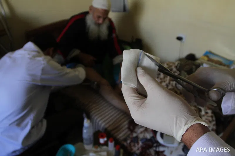 Palestinian doctors treats an elderly man at his home in Gaza City, on Feb. 22, 2014. "Ainucar Consulting and medical services" group include the Palestinian graduates doctors, nurses and medical Technology, to overcome...