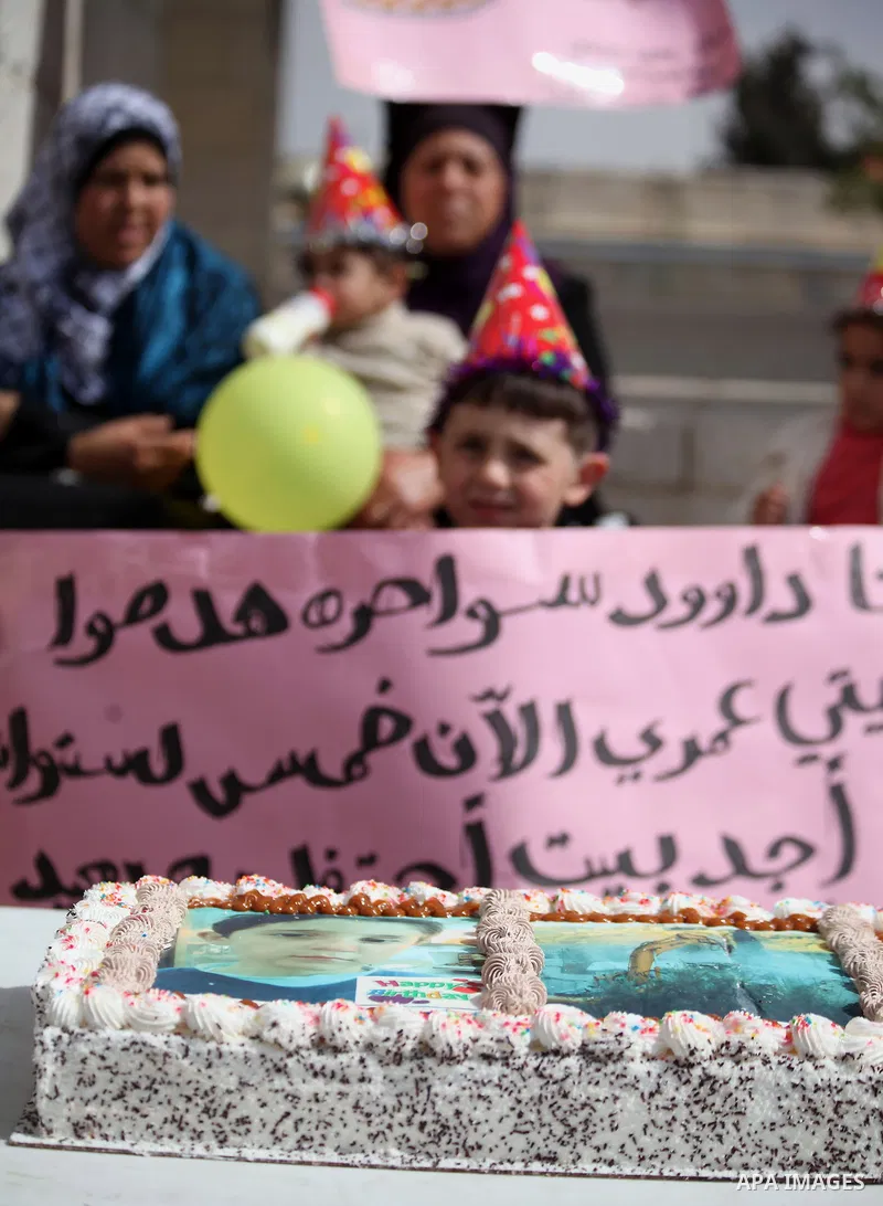 Palestinian members of Al Sawahra family celebrate Daoud Al Sawahra, 5, birthday at the yard of Jerusalem Municipality in a protest against demolishing their house by Israeli authority in Jerusalem, on Feb. 23, 2014. Isr...