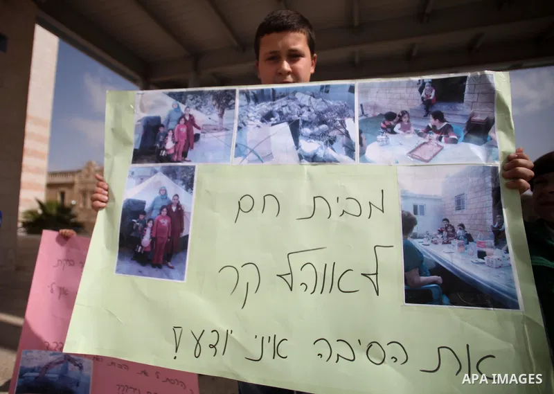 Palestinian members of Al Sawahra family celebrate Daoud Al Sawahra, 5, birthday at the yard of Jerusalem Municipality in a protest against demolishing their house by Israeli authority in Jerusalem, on Feb. 23, 2014. Isr...