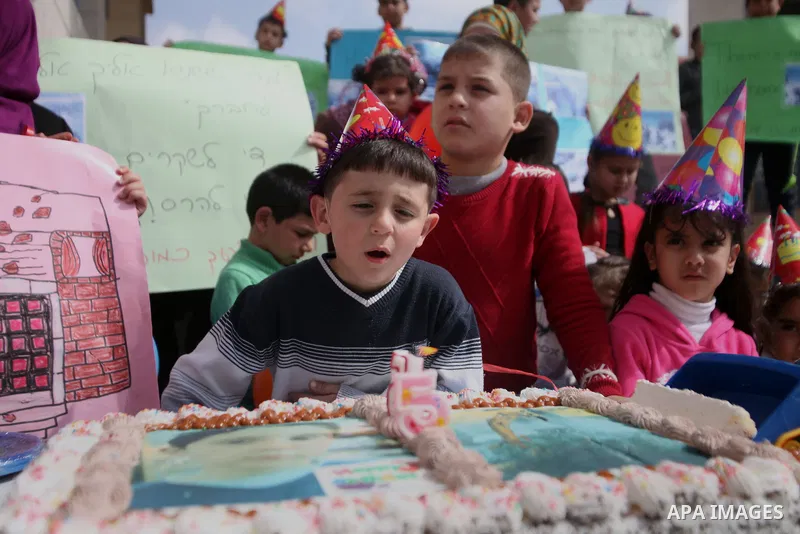 Palestinian members of Al Sawahra family celebrate Daoud Al Sawahra, 5, birthday at the yard of Jerusalem Municipality in a protest against demolishing their house by Israeli authority in Jerusalem, on Feb. 23, 2014. Isr...