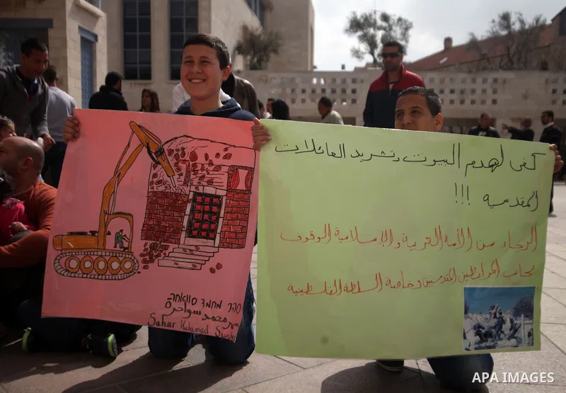Palestinian members of Al Sawahra family celebrate Daoud Al Sawahra, 5, birthday at the yard of Jerusalem Municipality in a protest against demolishing their house by Israeli authority in Jerusalem, on Feb. 23, 2014. Isr...