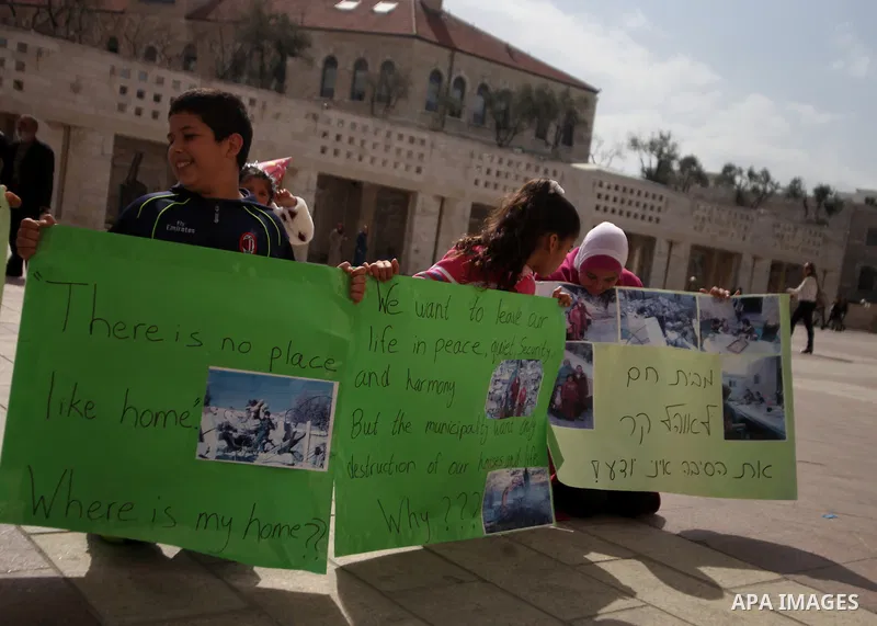 Palestinian members of Al Sawahra family celebrate Daoud Al Sawahra, 5, birthday at the yard of Jerusalem Municipality in a protest against demolishing their house by Israeli authority in Jerusalem, on Feb. 23, 2014. Isr...