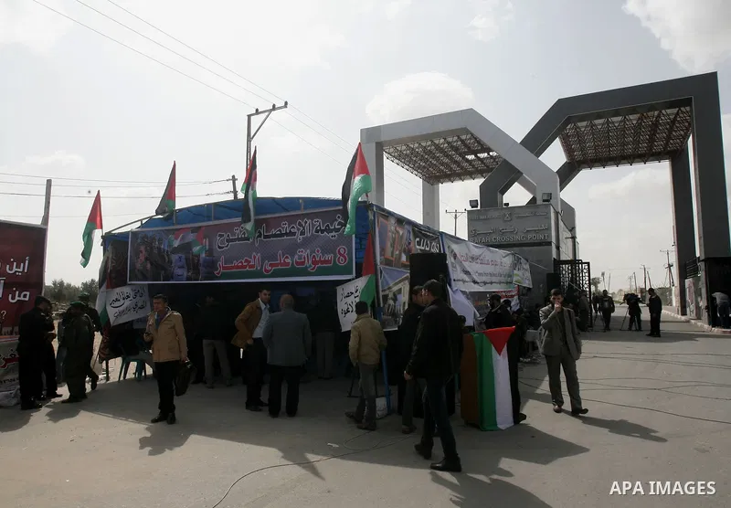 Palestinians take part during a protest tent in front of the Rafah border crossing between Egypt and the southern Gaza Strip, on Feb. 23, 2014. The crossing, which is the sole connection between the Gaza Strip's 1.5 mill...