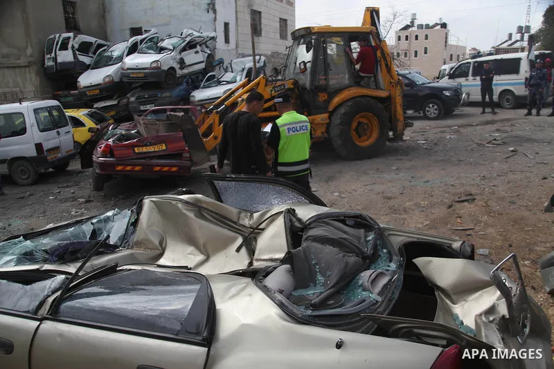 Palestinian police members use a bulldozer to destroy cars during a campaign destroy illegal cars in the West Bank City of Hebron, February 23, 2014. A majority of the so-called "illegal" vehicles are cars bought or stol...