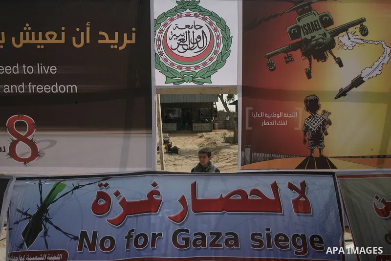 A Palestinian boy stands near a tent housing a special session attended by Hamas MPs at Rafah on February 23, 2014, to demand that Egypt lift border crossing restrictions. Egypt imposed the restrictions as part of a camp...