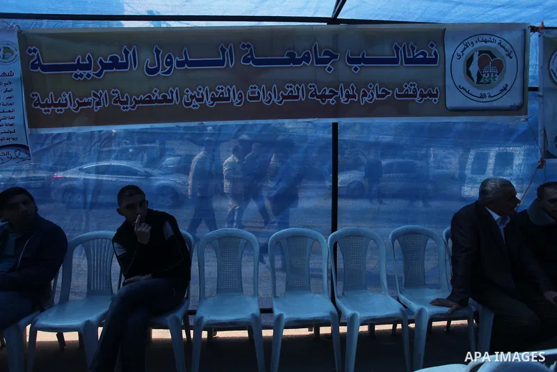 Palestinians take part in a protest demanding the release of their relatives prisoners held in Israeli jails, in front of the Red Cross office in Gaza City, on Feb. 24, 2014. Photo by Ashraf Amra