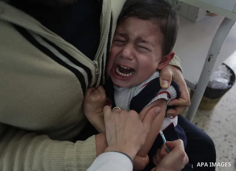 A Palestinian boy receives polio vaccine " measles" at a hospital in Gaza February 24, 2014. Photo by Ashraf Amra