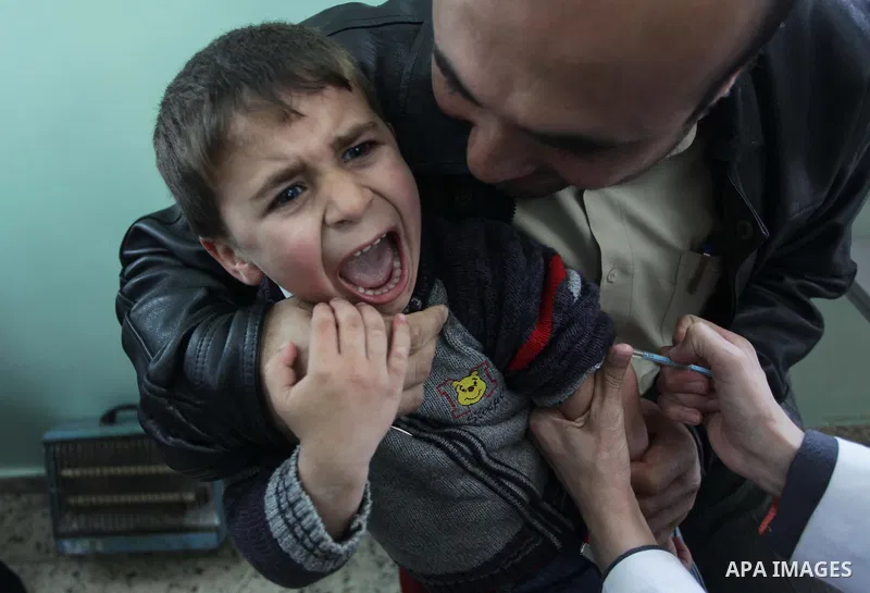 A Palestinian boy receives polio vaccine " measles" at a hospital in Gaza February 24, 2014. Photo by Ashraf Amra