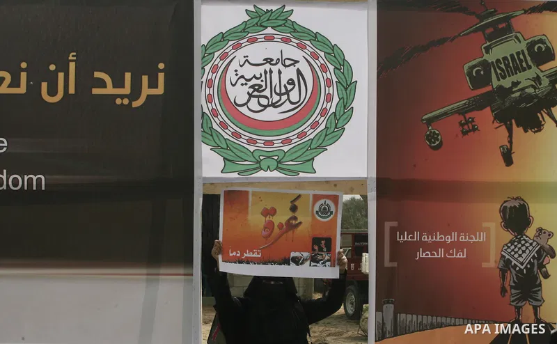 A Palestinian woman holds a banner during a protest in front of the Rafah border crossing with Egypt in the southern Gaza Strip on February 24, 2014, to demand that Egypt lift border crossing restrictions. Egypt imposed...