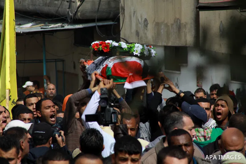 Palestinians carry a coffin said to contain the body of Palestinian militant Sarhan Al- Sarhan who was killed 13 years ago during his funeral in Tulkarem Refugee Camp in the West Bank, 24 February 2014. The body is one o...