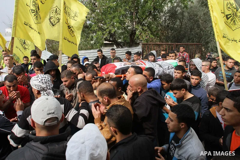 Palestinians carry a coffin said to contain the body of Palestinian militant Sarhan Al- Sarhan who was killed 13 years ago during his funeral in Tulkarem Refugee Camp in the West Bank, 24 February 2014. The body is one o...