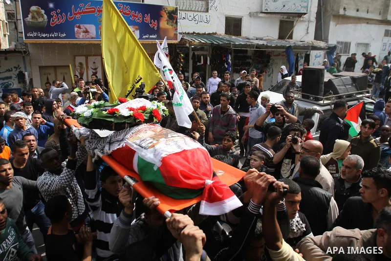 Palestinians carry a coffin said to contain the body of Palestinian militant Sarhan Al- Sarhan who was killed 13 years ago during his funeral in Tulkarem Refugee Camp in the West Bank, 24 February 2014. The body is one o...