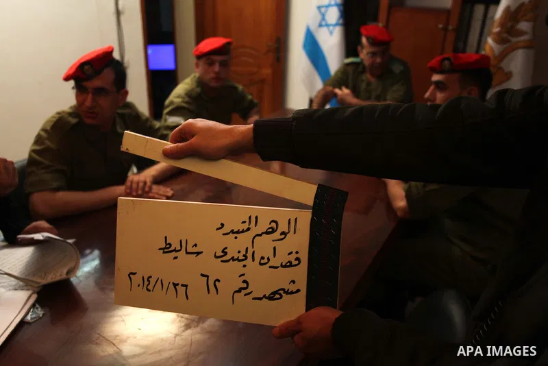 A photo taken on Jan 26, 2014 shows Palestinian actors dressed as Israeli soldiers sit during filming in a movie being made in Gaza called, ''Losing Shalit," in Gaza City. "Losing Schalit," currently being filmed in the...