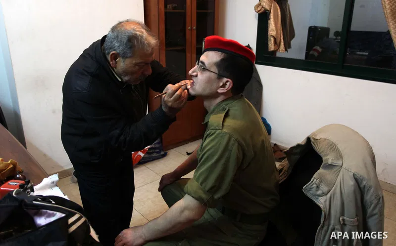 A photo taken on Jan 26, 2014 shows Gilad Schalit to the likeness of actor Mahmoud Karira, has makeup applied by assistant takes during filming in a movie being made in Gaza called, ''Losing Shalit," in Gaza City. "Losin...