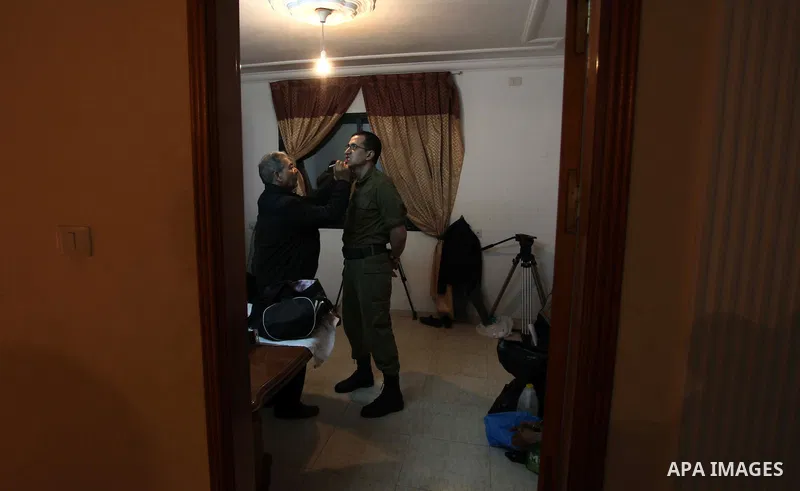 A photo taken on Jan 26, 2014 shows Gilad Schalit to the likeness of actor Mahmoud Karira, has makeup applied by assistant takes during filming in a movie being made in Gaza called, ''Losing Shalit," in Gaza City. "Losin...