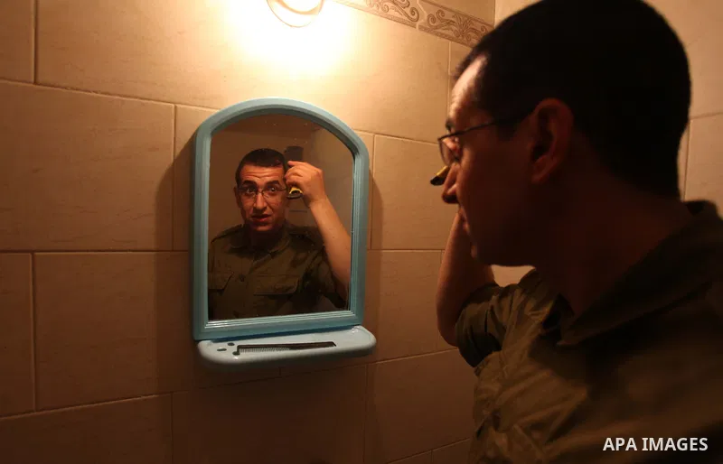 A photo taken on Jan 26, 2014 shows Gilad Schalit to the likeness of actor Mahmoud Karira, combs his hair in between takes of filming in movie being made in Gaza called, ''Losing Shalit," in Gaza City. "Losing Schalit,"...
