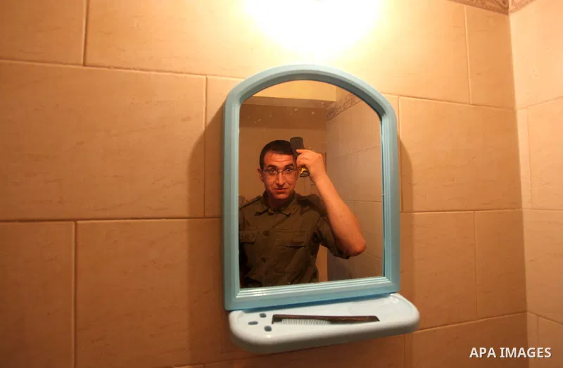 A photo taken on Jan 26, 2014 shows Gilad Schalit to the likeness of actor Mahmoud Karira, combs his hair in between takes of filming in movie being made in Gaza called, ''Losing Shalit," in Gaza City. "Losing Schalit,"...
