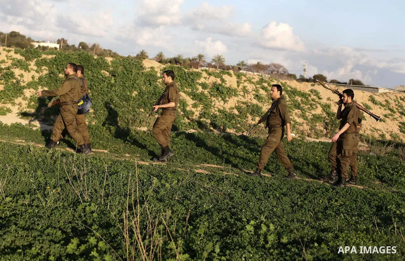 A photo taken on Feb. 17, 2014 shows Palestinian actors dressed as Israeli soldiers walk during filming in a movie being made in Gaza called, ''Losing Shalit," in Gaza City. "Losing Schalit," currently being filmed in th...