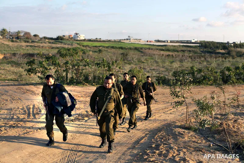 A photo taken on Feb. 17, 2014 shows Palestinian actors dressed as Israeli soldiers walk during filming in a movie being made in Gaza called, ''Losing Shalit," in Gaza City. "Losing Schalit," currently being filmed in th...
