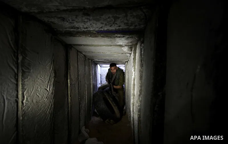 A photo taken on Feb. 17, 2014 shows A Palestinian actor dressed as an Israeli soldier walks in a tunnel during filming in a movie being made in Gaza called, ''Losing Shalit," in Gaza City. "Losing Schalit," currently be...