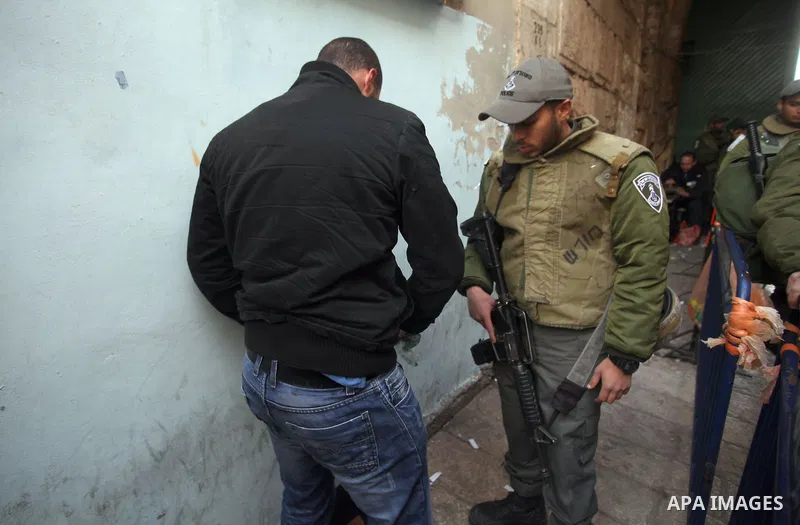 Israeli security forces checks the bag of Palestinian man while he wait to cross an alleyway leading to the al-Aqsa Mosque compound on February 25, 2014 in the Old City of Jerusalem. Israeli police early today entered th...