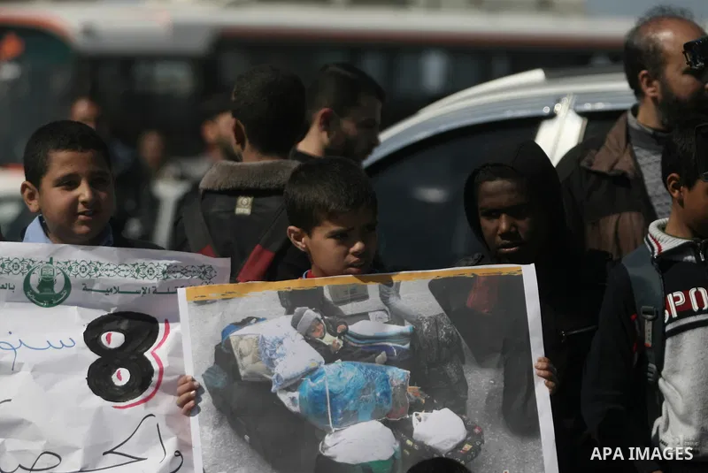 Palestinians hold banners during a protest in front of the Rafah border crossing with Egypt in the southern Gaza Strip on February 24, 2014. to demand that Egypt lift border crossing restrictions. Egypt imposed the restr...
