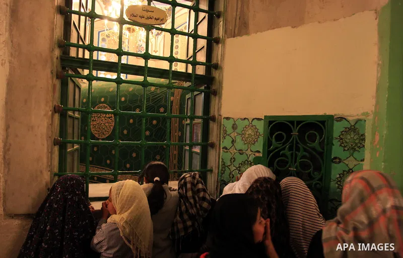 Palestinian girls visit the Ibrahimi Mosque in the southern West Bank city of Hebron on February 25, 2014. On February 25, 1994, Israeli settler Baruch Goldstein used an assault rifle to gun down worshippers in the Ibrah...