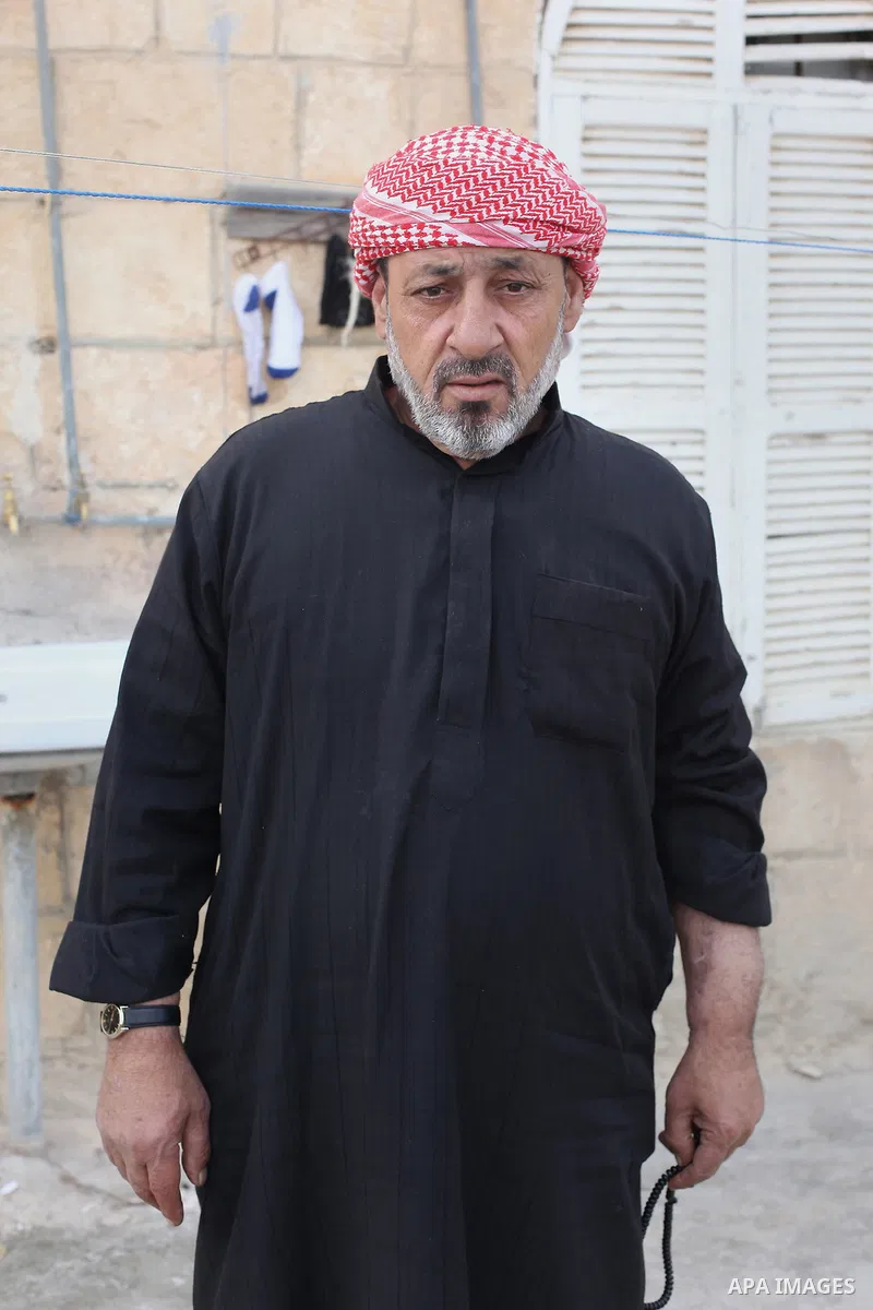 Ahmad Mansour, 54, poses for a picture at his house in the village of al-Kitteh western city of Jerash, 50 km northern the Jordanian capital Amman on February 21, 2014 . Mansour arrived on foot on a stretcher as a Syrian...