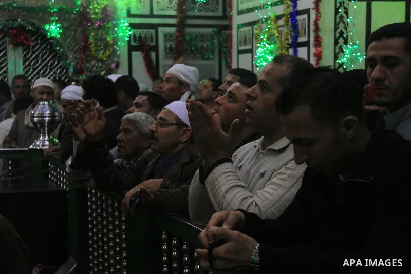 Worshippers attend the El Ishaa prayers at the Al-Hussein mosque, during celebration day of "Moulid Al-Hussein" the birthday of Prophet Mohammad's grandson Hussein in Cairo, February 25, 2014. Photo by Mohammed Bendari