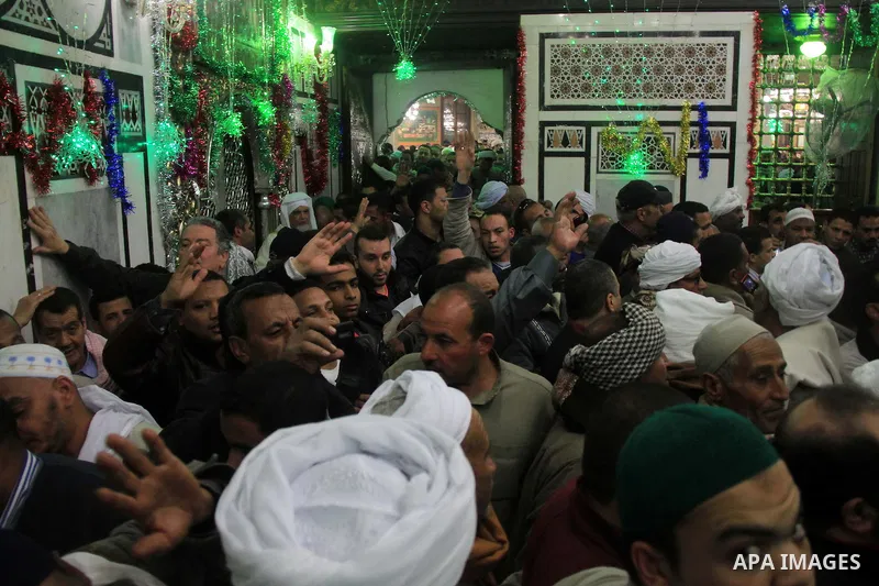 Worshippers attend the El Ishaa prayers at the Al-Hussein mosque, during celebration day of "Moulid Al-Hussein" the birthday of Prophet Mohammad's grandson Hussein in Cairo, February 25, 2014. Photo by Mohammed Bendari
