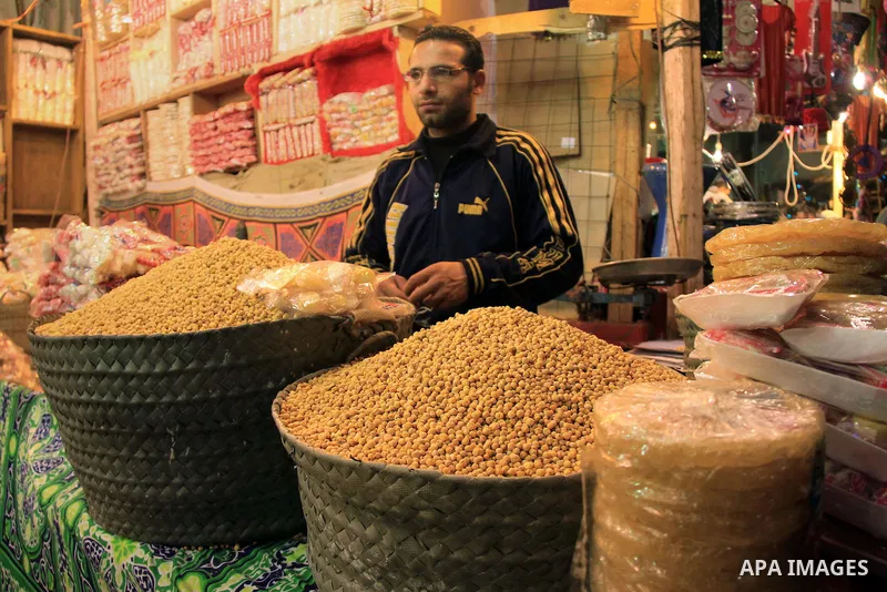A Egyptian man sells nuts and sweets to worshippers after El Ishaa prayers at the Al-Hussein mosque, during celebration day of "Moulid Al-Hussein" the birthday of Prophet Mohammad's grandson Hussein in Cairo, February 25...
