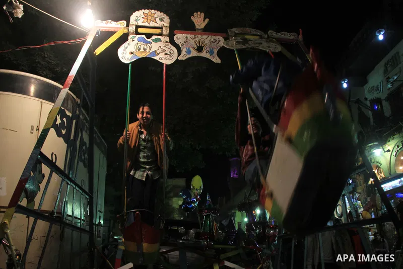 Egyptians play in front of the Al-Hussein mosque, during celebration day of "Moulid Al-Hussein" the birthday of Prophet Mohammad's grandson Hussein in Cairo, February 25, 2014. Photo by Mohammed Bendari