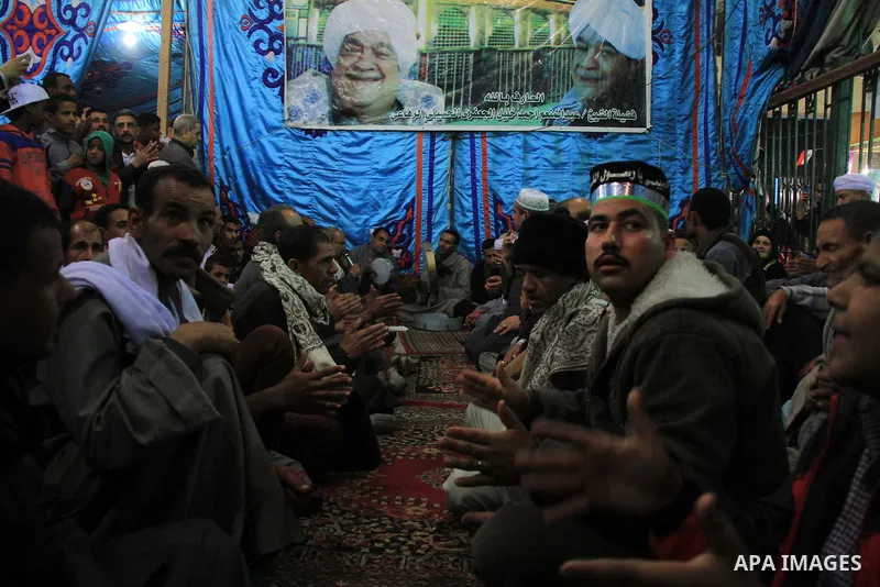 Worshippers attend the El Ishaa prayers at the Al-Hussein mosque, during celebration day of "Moulid Al-Hussein" the birthday of Prophet Mohammad's grandson Hussein in Cairo, February 25, 2014. Photo by Mohammed Bendari