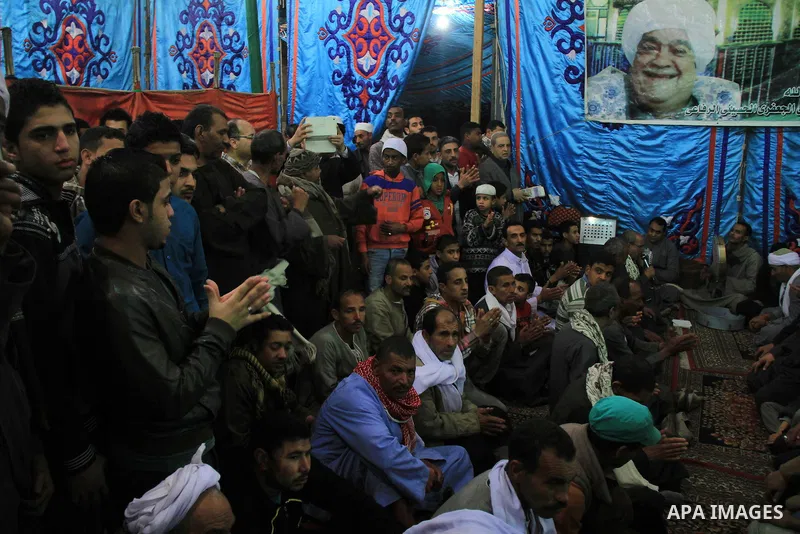 Worshippers attend the El Ishaa prayers at the Al-Hussein mosque, during celebration day of "Moulid Al-Hussein" the birthday of Prophet Mohammad's grandson Hussein in Cairo, February 25, 2014. Photo by Mohammed Bendari