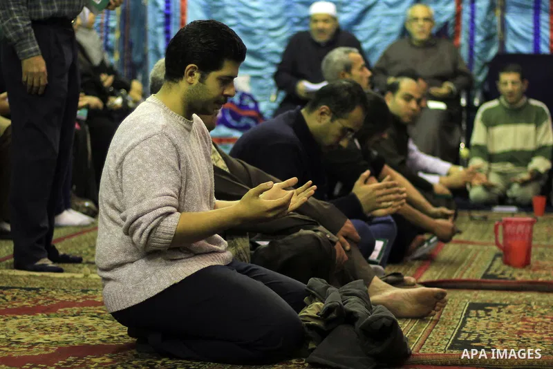 Worshippers attend the El Ishaa prayers at the Al-Hussein mosque, during celebration day of "Moulid Al-Hussein" the birthday of Prophet Mohammad's grandson Hussein in Cairo, February 25, 2014. Photo by Mohammed Bendari