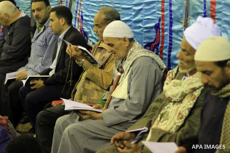 Worshippers read the Koran at the Al-Hussein mosque, during celebration day of "Moulid Al-Hussein" the birthday of Prophet Mohammad's grandson Hussein in Cairo, February 25, 2014. Photo by Mohammed Bendari