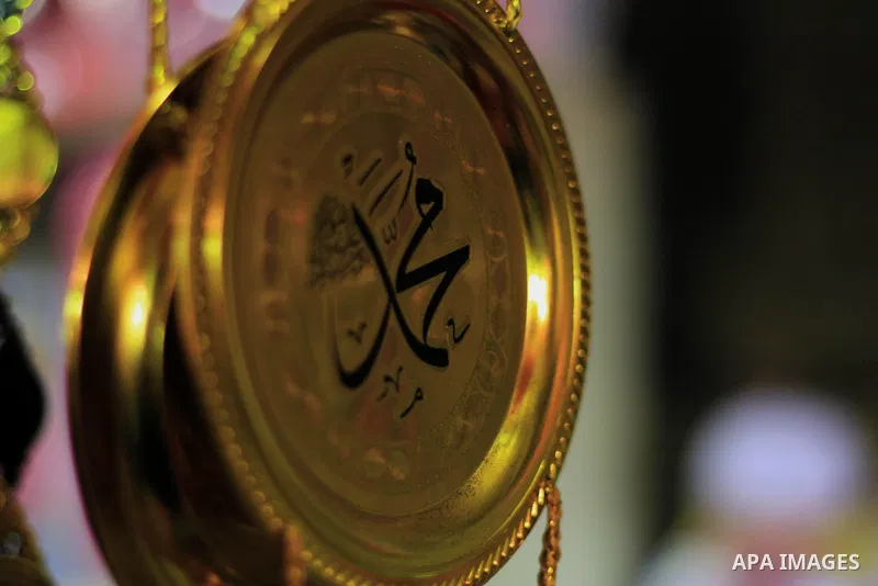 A Egyptian man sells copper works to worshippers after El Ishaa prayers at the Al-Hussein mosque, during celebration day of "Moulid Al-Hussein" the birthday of Prophet Mohammad's grandson Hussein in Cairo, February 25, 2...