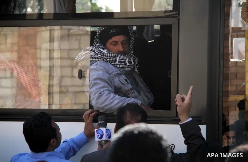 Relatives of seven Egyptian victims who were found shot dead in Jalluta, near Benghazi in eastern Libya, wait as ambulances drive out of Cairo international airport carrying their bodies, on February 26, 2014. The victim...