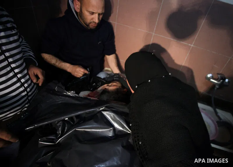 Palestinians gather around the body of Prisoner Jihad al-Tawil ,47, during his funeral in Jerusalem on February 26, 2014. Prisoner Jihad al-Tawil, from Jerusalem died Tuesday in Soroka Israeli Medical Center in Beersheba...