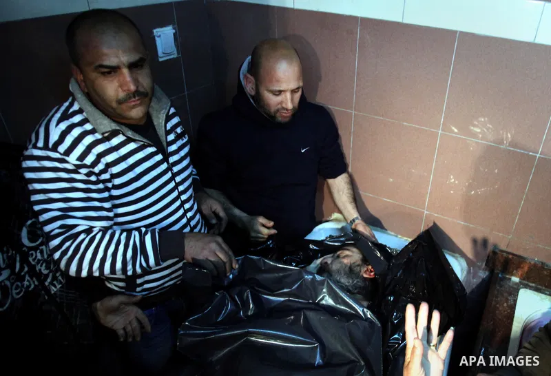 Palestinians gather around the body of Prisoner Jihad al-Tawil ,47, during his funeral in Jerusalem on February 26, 2014. Prisoner Jihad al-Tawil, from Jerusalem died Tuesday in Soroka Israeli Medical Center in Beersheba...