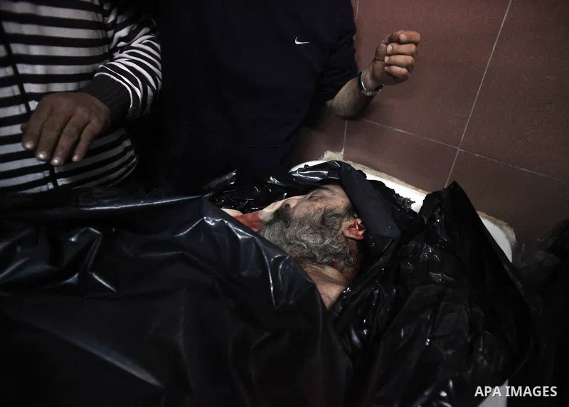 Palestinians gather around the body of Prisoner Jihad al-Tawil ,47, during his funeral in Jerusalem on February 26, 2014. Prisoner Jihad al-Tawil, from Jerusalem died Tuesday in Soroka Israeli Medical Center in Beersheba...