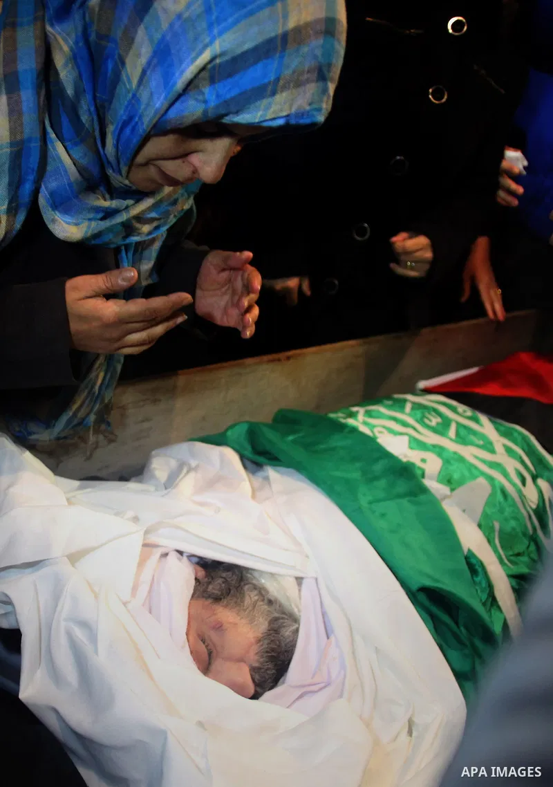 Palestinians gather around the body of Prisoner Jihad al-Tawil ,47, during his funeral in Jerusalem on February 26, 2014. Prisoner Jihad al-Tawil, from Jerusalem died Tuesday in Soroka Israeli Medical Center in Beersheba...