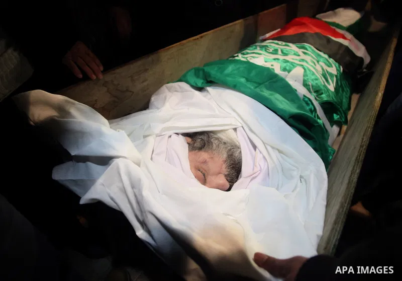 Palestinians gather around the body of Prisoner Jihad al-Tawil ,47, during his funeral in Jerusalem on February 26, 2014. Prisoner Jihad al-Tawil, from Jerusalem died Tuesday in Soroka Israeli Medical Center in Beersheba...