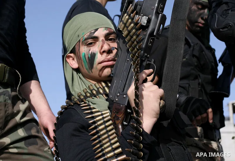 Palestinian students take part in a military march organised by Hamas national security in a street in Rafah town, in the southern Gaza Strip, on February 27, 2014. Thousands of youngsters between the age of six and 16,...