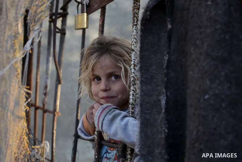 A Palestinian girl plays outside her family's house in Beit Lahia, northern Gaza Strip February 27, 2014. Photo by Ashraf Amra