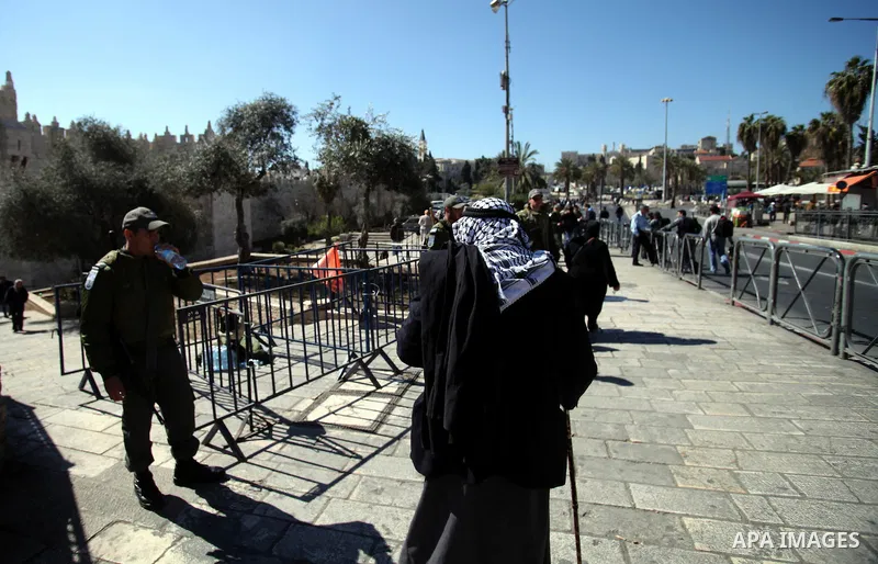 Muslim Palestinians take part in Friday noon prayers blocked by Israeli police in East Jerusalem neighborhood of Ras al-Amud, on February 28, 2014. Clashes broke out following Friday noon prayer three days after police c...